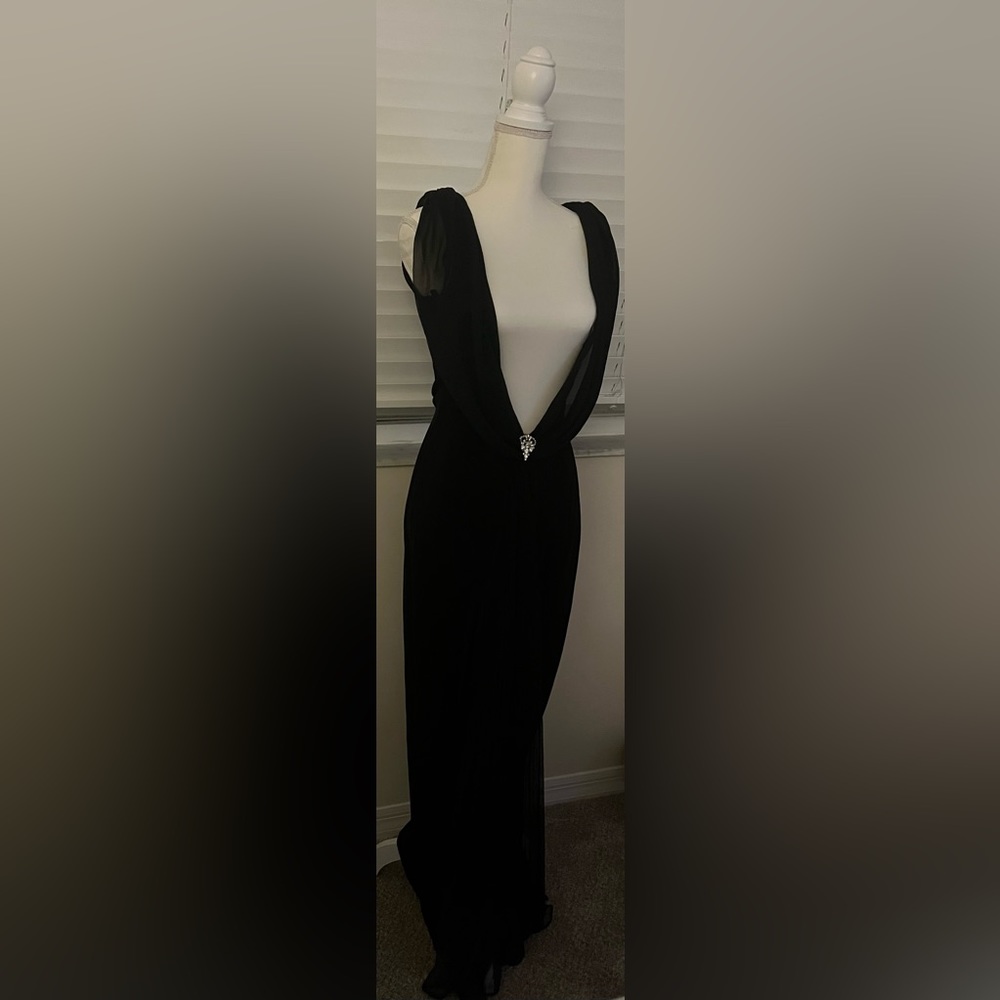 Dazzle in this black strapless evening gown.